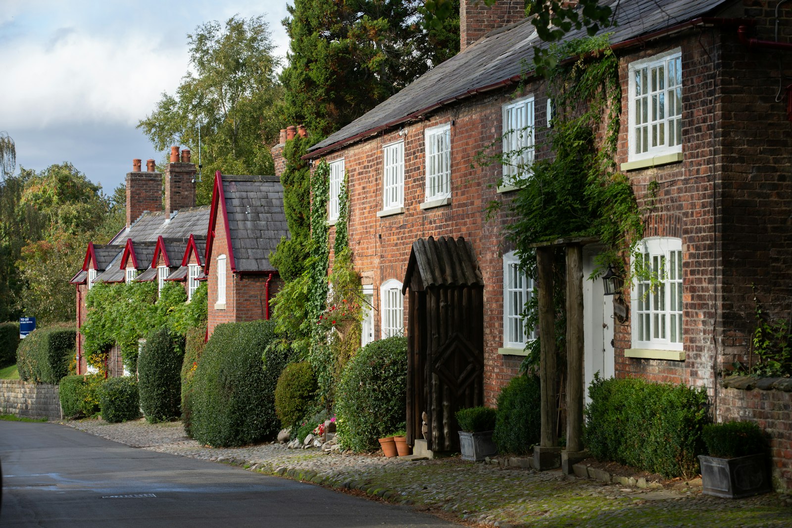 A period house set among mature trees and greenery